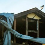 How to Cover a Tarp on the Roof of a House