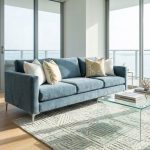 Chic Miami apartment living room with dusty blue sofa and coastal decor accents