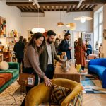 Visitors explore a colorful and textured furniture showroom during Paris Design Week 2026, with bold upholstered seating and handcrafted decorative objects on display