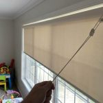 Living room shades stuck near sunny Phoenix window