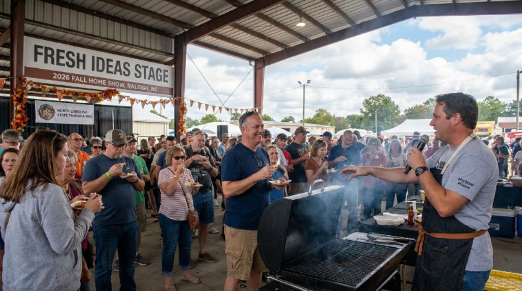 Michael Mixon delivering a live barbecue demonstration with audience members tasting samples on the Fresh Ideas Stage at the fall home show at the North Carolina State Fairgrounds in Raleigh, September 2026