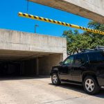 Large SUV parked inside a residential garage with limited ceiling clearance