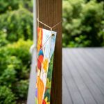 Properly secured porch banner with reinforced mounting hardware